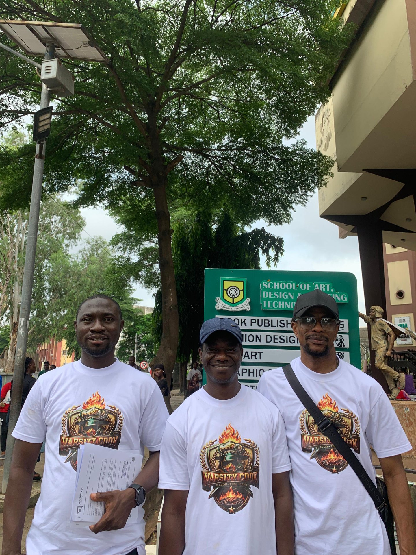 Varsity Cook team members outside YABATECH campus building